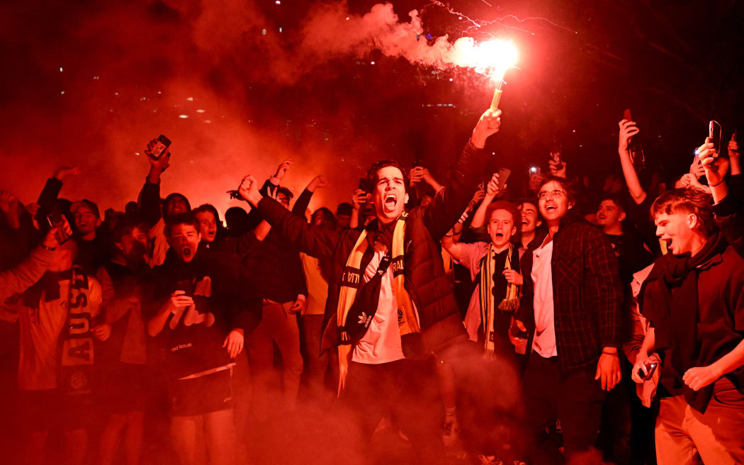 Australian fans celebrate in Melbourne on 1 December, 2022, after Australia's victory over Denmark in their Qatar 2022 World Cup Group D football match.