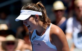 The Spanish tennis player Garbine Muguruza celebrates winning a point.