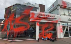 The facade of Gazley Motor Group on Cambridge Terrace, defaced by protesters.