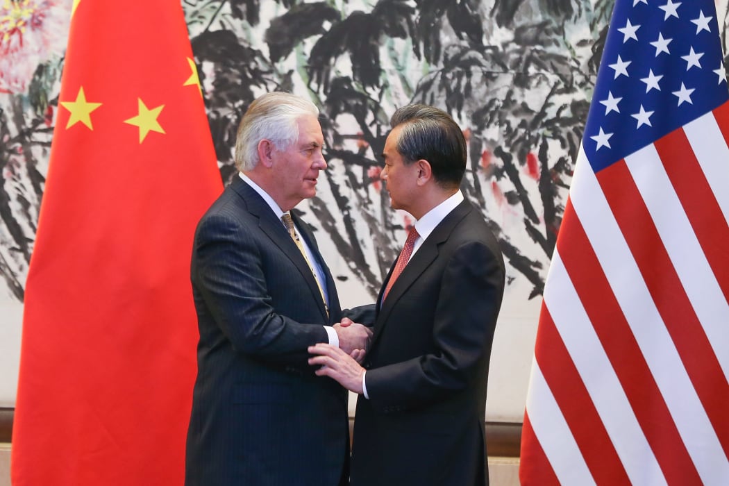 China's Foreign Minister Wang Yi (R) shakes hands with US Secretary of State Rex Tillerson after a joint press conference at the Diaoyutai State Guesthouse in Beijing on March 18