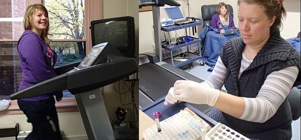 Study participant Kelly Brown (left) walks on the treadmill for two minutes every half hour as part of a study looking at breaking sitting time, while Meredith Peddie processes blood samples that will be analysed for sugar and fat levels.