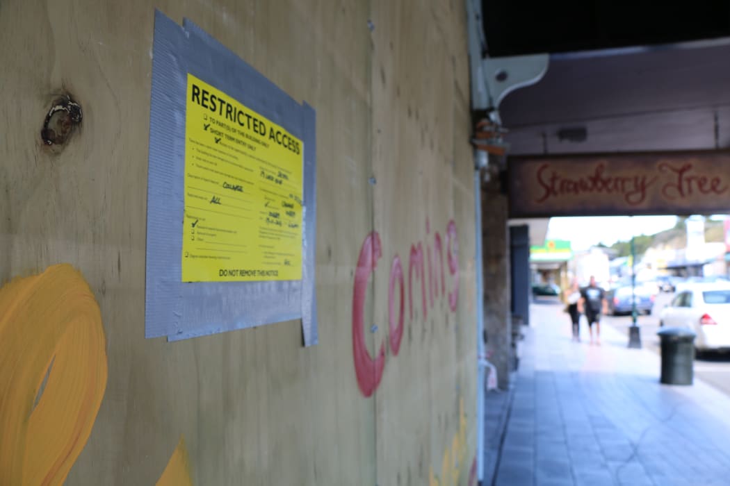 A yellow sticker on a building on Kaikoura's main street.
