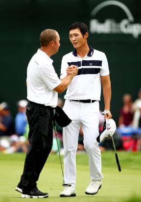Danny Lee shakes hands with Chad Collins on the 18th hole during the final round of the Greenbrier Classic.