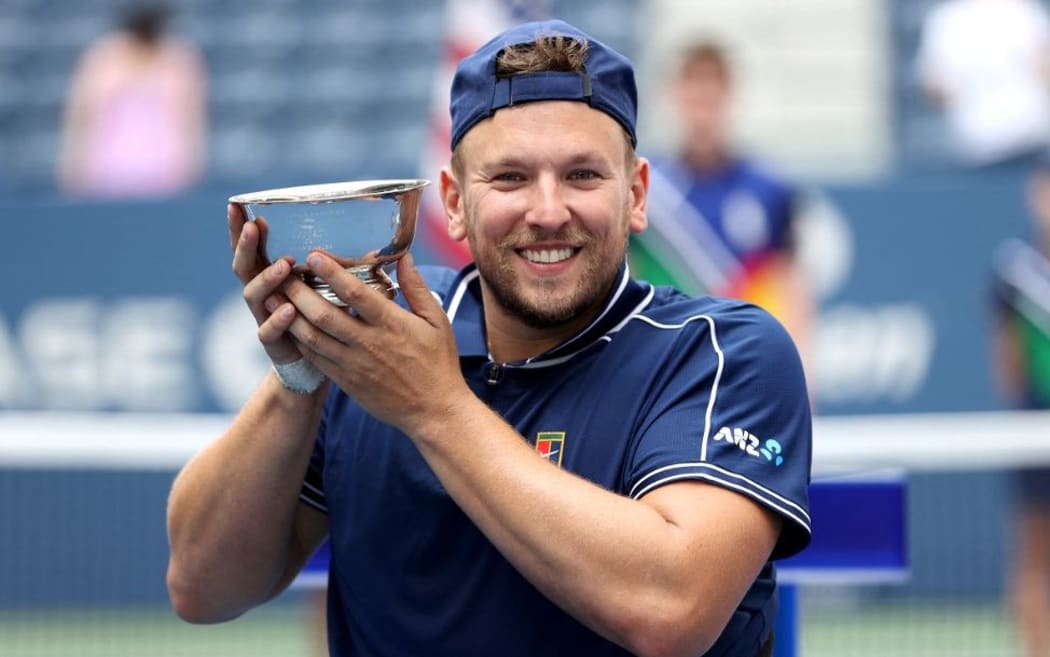 NEW YORK, NEW YORK - SEPTEMBER 12: Dylan Alcott of Australia celebrates with the championship trophy after defeating Niels Vink of the Netherlands to complete a 'Golden Slam' during their Wheelchair Quad Singles final match on Day Fourteen of the 2021 US Open