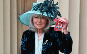 Author Jilly Cooper poses with her medal after she was appointed a Commander of the Order of the British Empire (CBE) at an investiture ceremony at Buckingham Palace in London on 20 March 2018.