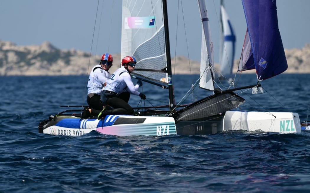 New Zealand's duo Micah Wilkinson and Erica Dawson compete in the medal race of the mixed Nacra 17 multihull event during the Paris 2024 Olympic Games sailing competition at the Roucas-Blanc Marina in Marseille on August 8, 2024. (Photo by Christophe SIMON / AFP)