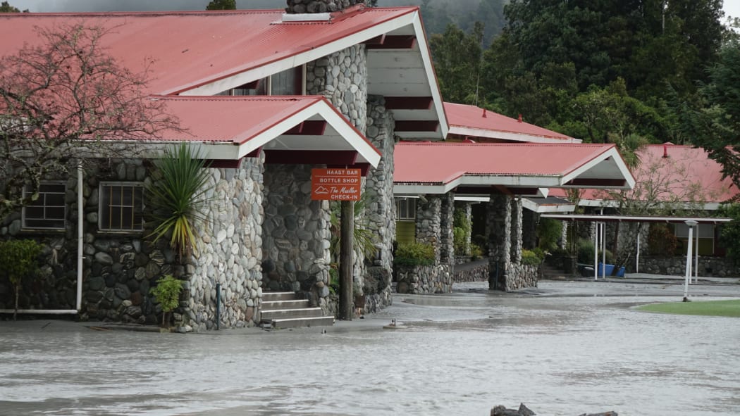 The Waiho River bursts its banks and runs through the Mueller Hotel in Franz Josef