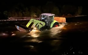 A tractor got stuck in a swollen Otututu River on the West Coast on Saturday night.