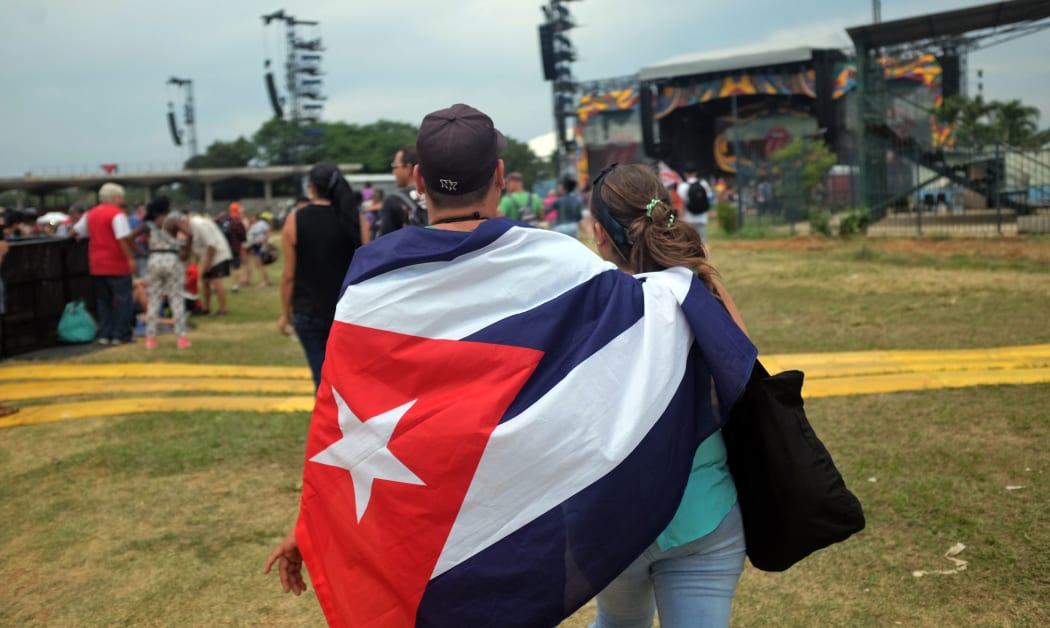 Fans draped in the Cuban flag wait for the Rolling Stones concert to start.