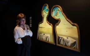 India from Kingston, Wellington, views Salvador Dalí's Couple With Their Heads Full Of Clouds, 1936, in Te Papa's Surrealist Art: Masterpieces from Museum Boijmans Van Beuningen exhibition.