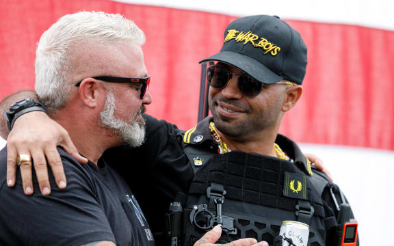 Leaders of the Proud Boys, a right-wing pro-Trump group, Enrique Tarrio (right) and Joe Biggs (left) embrace each other as the Proud boys members gather with their allies in a rally called "End Domestic Terrorism"  against Antifa in Portland, Oregon on 26 September, 2020.