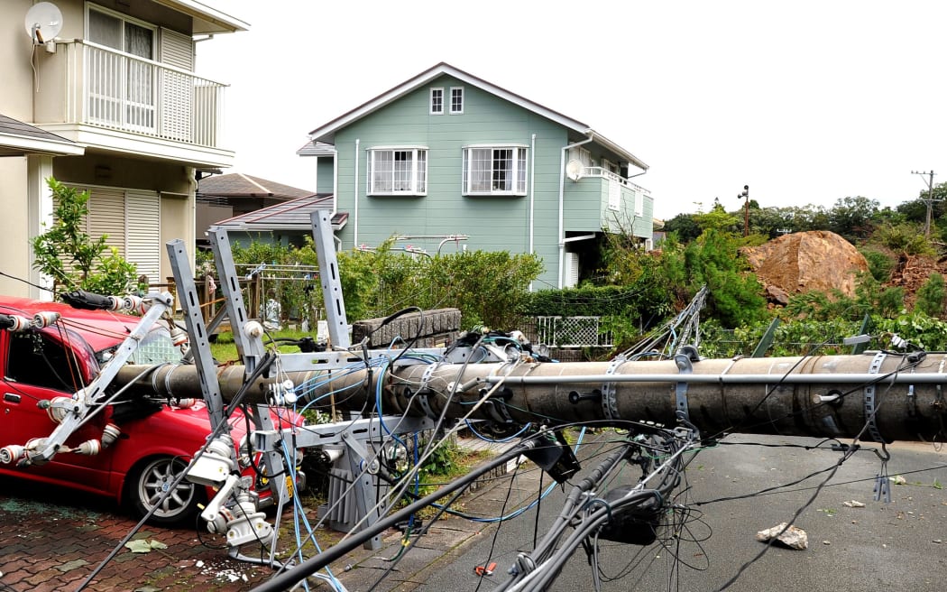 A utility pole crushed a car when it fell due after a landslide.