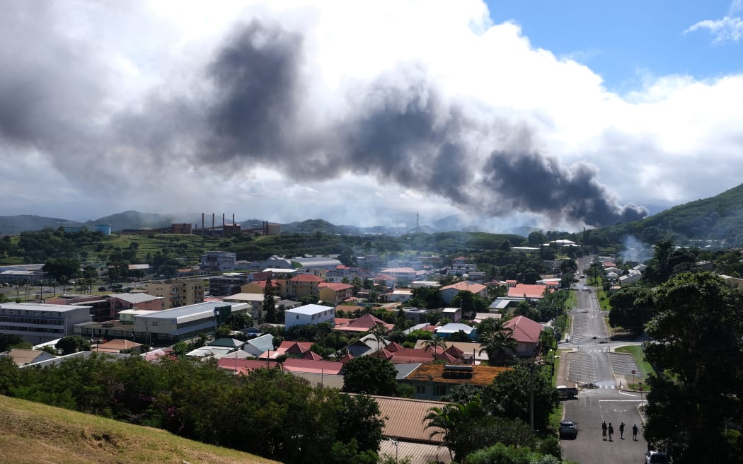 Smoke rising in Nouméa on 14 May 2024 amid protests linked to a constitutional bill aimed at enlarging the electorate for the overseas French territory of New Caledonia. . (Photo by Theo Rouby / AFP)