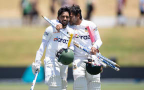 Bangladesh's captain Mominul Haque (L) with team mate Mushfiqur Rahim celebrate win over Black Caps.
