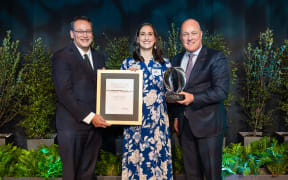 Olivia Harrison poses for a photo with Minister for Science, Shane Reti, on her right, and Prime Minister Christopher Luxon on her left.