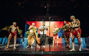 Members of the Nunukul Yuggera Aboriginal dance group on stage with Six60.