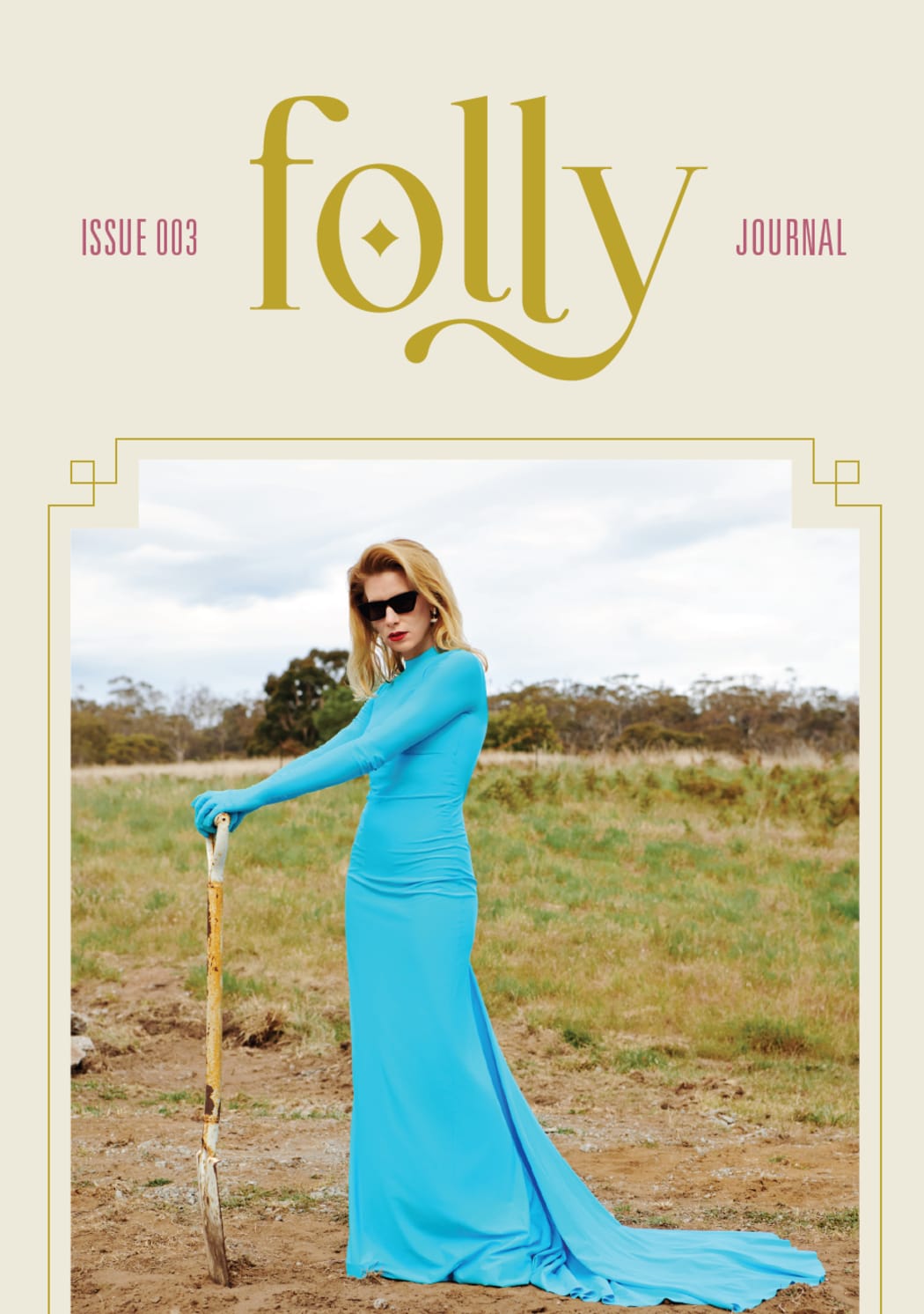 The cover of Folly Magazine, Issue 003. A woman in a blue dress stands in a field with a shovel.