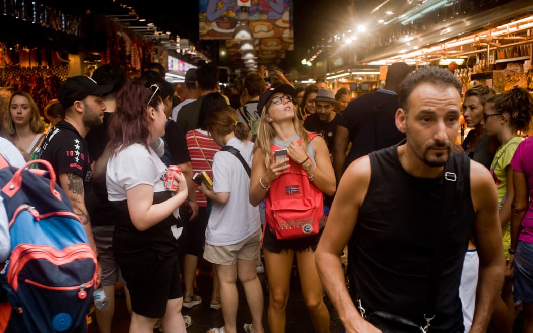 Tourists visit La Boqueria market on August 8, 2017 in Barcelona, Spain.