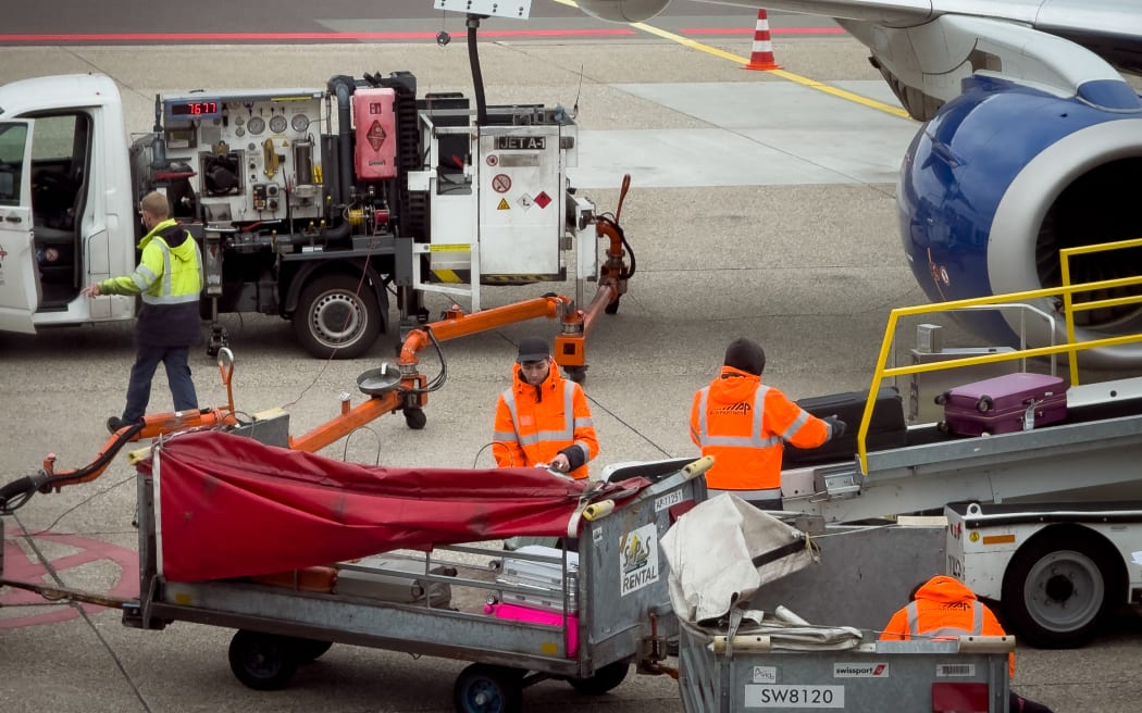 Ground staff refuel and unload baggage from a British Airways Embraer 190 (registration G-LCYM) after its arrival from London at Amsterdam Airport Schiphol in Amsterdam, the Netherlands, on October 29, 2025. (Photo by Mateusz Wlodarczyk/NurPhoto) (Photo by Mateusz Wlodarczyk / NurPhoto via AFP)