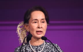 Myanmar State Counsellor Aung San Suu Kyi speaks at a business forum on the sidelines of the 33rd Association of Southeast Asian Nations (ASEAN) summit in Singapore on November 12, 2018. (Photo by Roslan RAHMAN / AFP)