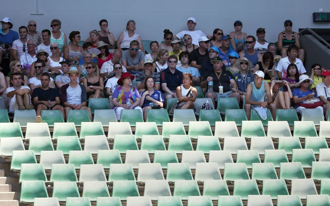 Spectators get a reprieve from the heat by sitting in the shadows at the Australian Open.