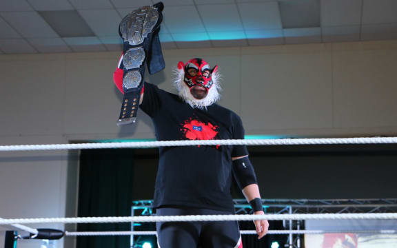 Liger/Michel Mulipola holds up his NZ Pro-Wrestling Championship belt.