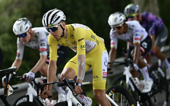 UAE Team Emirates - XRG team's Slovenian rider Tadej Pogacar wearing the overall leader's yellow jersey cycles with the pack of riders (peloton) during the 15th stage of the 112th edition of the Tour de France cycling race, 169.3 km between Muret and Carcassonne, southwestern France, on July 20, 2025. (Photo by Loic VENANCE / AFP)