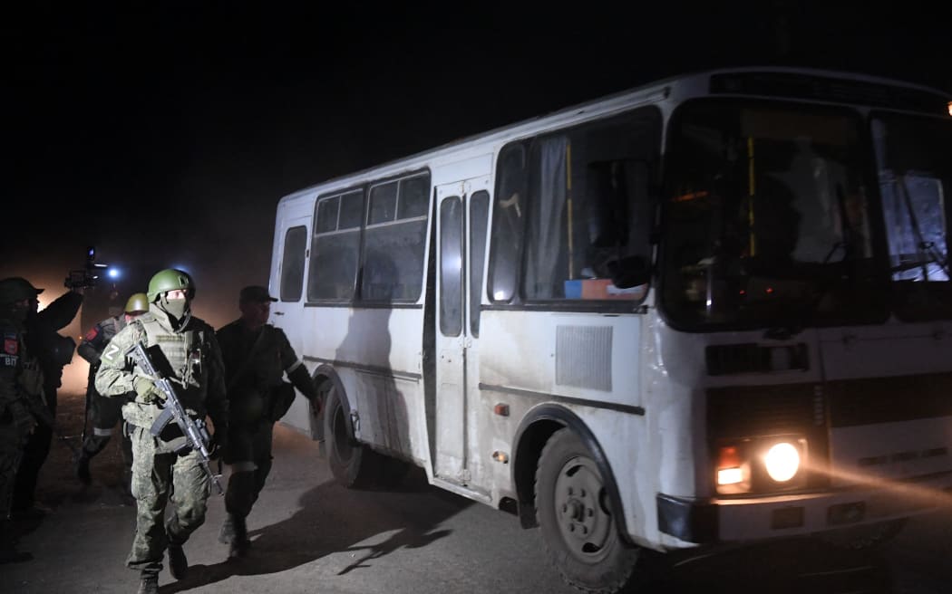 8192513 16.05.2022 DPR's servicemen accompany the bus with the wounded Ukrainian soldiers, in Mariupol, DPR. Russia and Ukraine have reached an agreement on the evacuation of wounded troops from the Azovstal metallurgical plant in Mariupol. A silence regime has been introduced in the area and a humanitarian corridor has been opened through which the wounded Ukrainian troops are delivered to a medical facility in Novoazovsk to provide them with all the necessary assistance Alexey Kudenko / Sputnik (Photo by Alexey Kudenko / Sputnik / Sputnik via AFP)