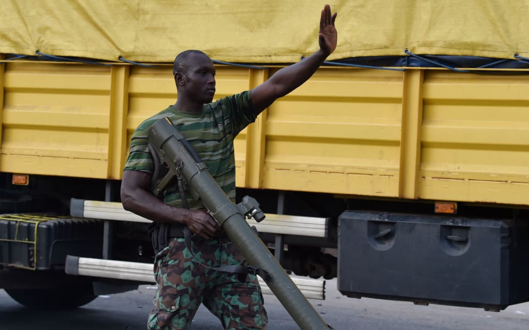 A mutinou soldier patrols in the streets of Ivory Coast's central second city Bouake, the country's second-largest city.