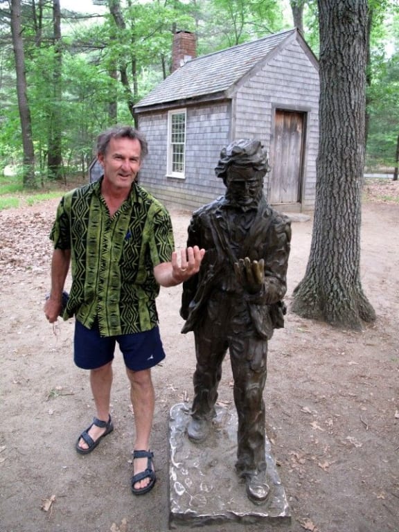 Kennedy Warne standing beside a statue of Henry David Thoreau
