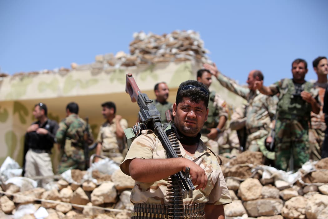 Iraqi Kurdish Peshmerga fighters in Bashiqa, north-east of Mosul, which has been taken by Islamic State militants.