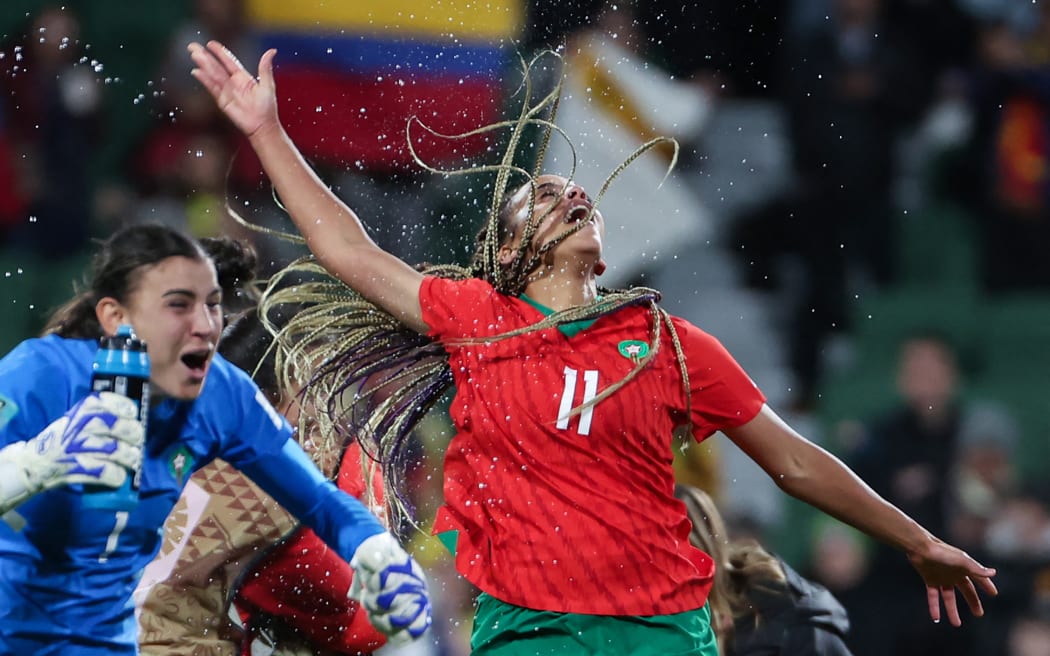 Morocco's goalkeeper #01 Khadija Er-Rmichi (L) and Morocco's forward #11 Fatima Tagnaout celebrate their team's victory and qualification to the knockout stage after the end of the Australia and New Zealand 2023 Women's World Cup Group H football match between Morocco and Colombia at Perth Rectangular Stadium in Perth on August 3, 2023. (Photo by Colin MURTY / AFP)