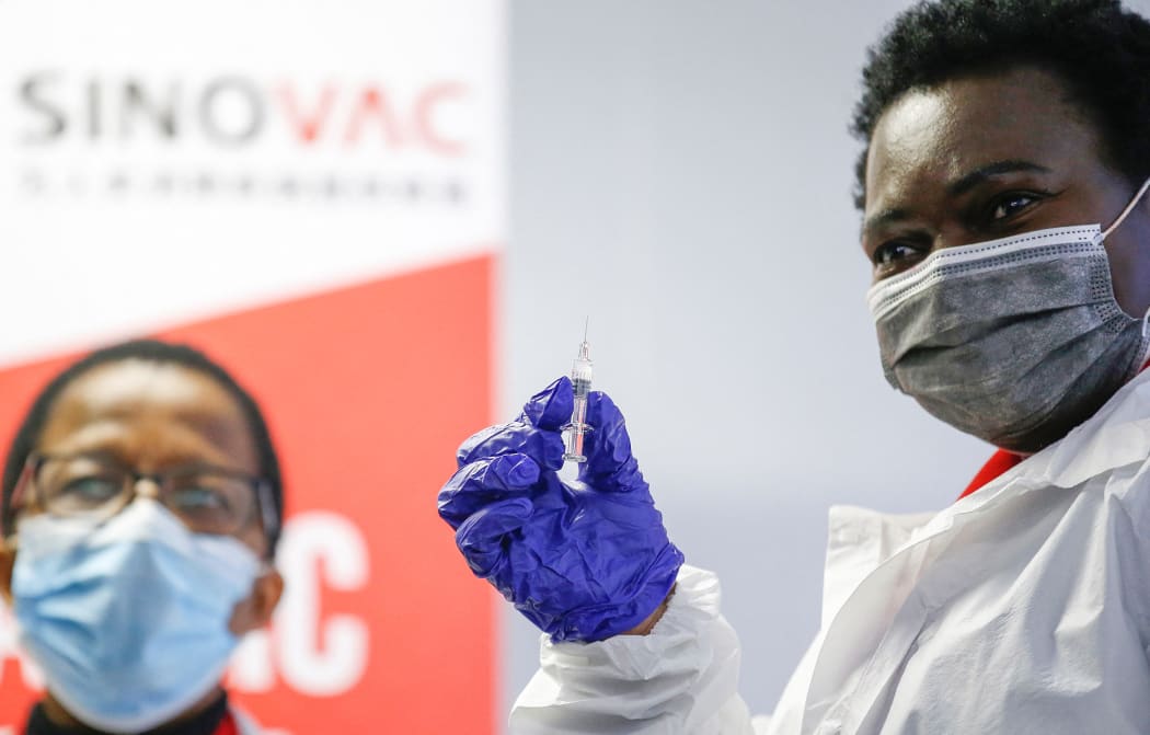 A healthcare worker holds up a SINOVAC Covid-19 vaccine before administering it on a minor during the Numolux/SINOVAC Peadiatric Covid-19 Vaccine Clinical Trial at the Sefako Makgatho Health Sciences University in Pretoria, on September 10, 2021. )