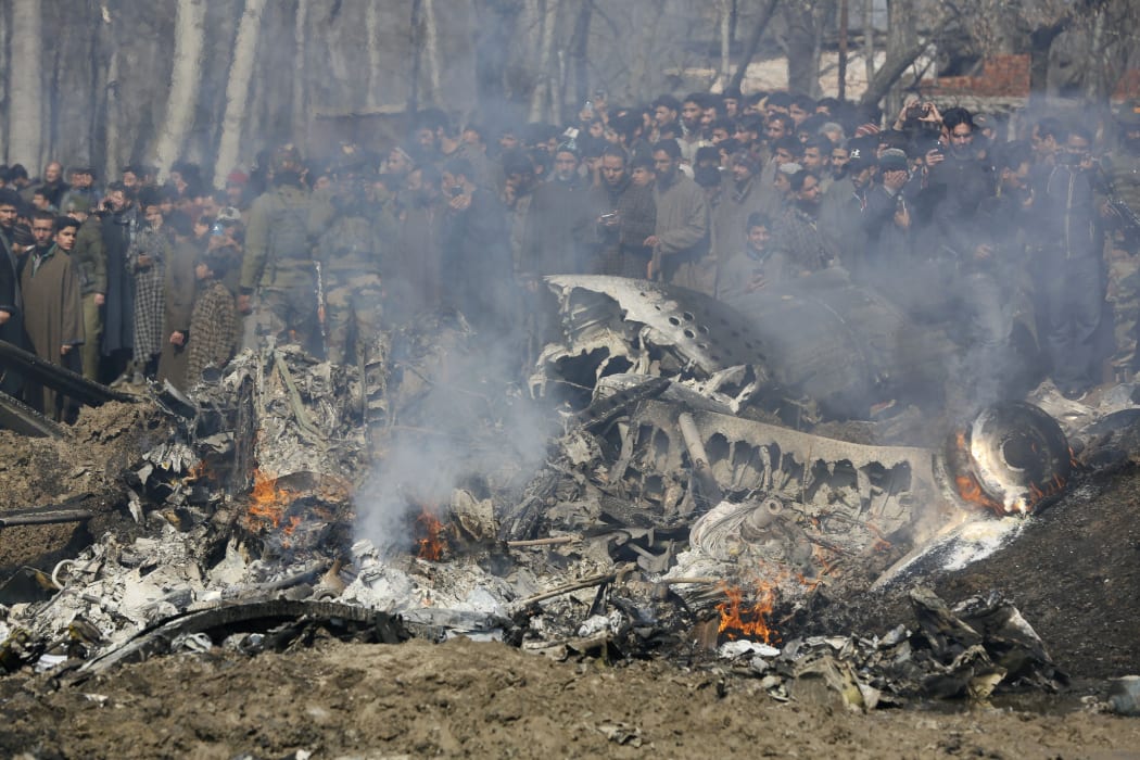 Kashmiri villagers gather near the wreckage of an Indian aircraft after it crashed in Budgam area, outskirts of Srinagar, Indian controlled Kashmir, on 27 February.