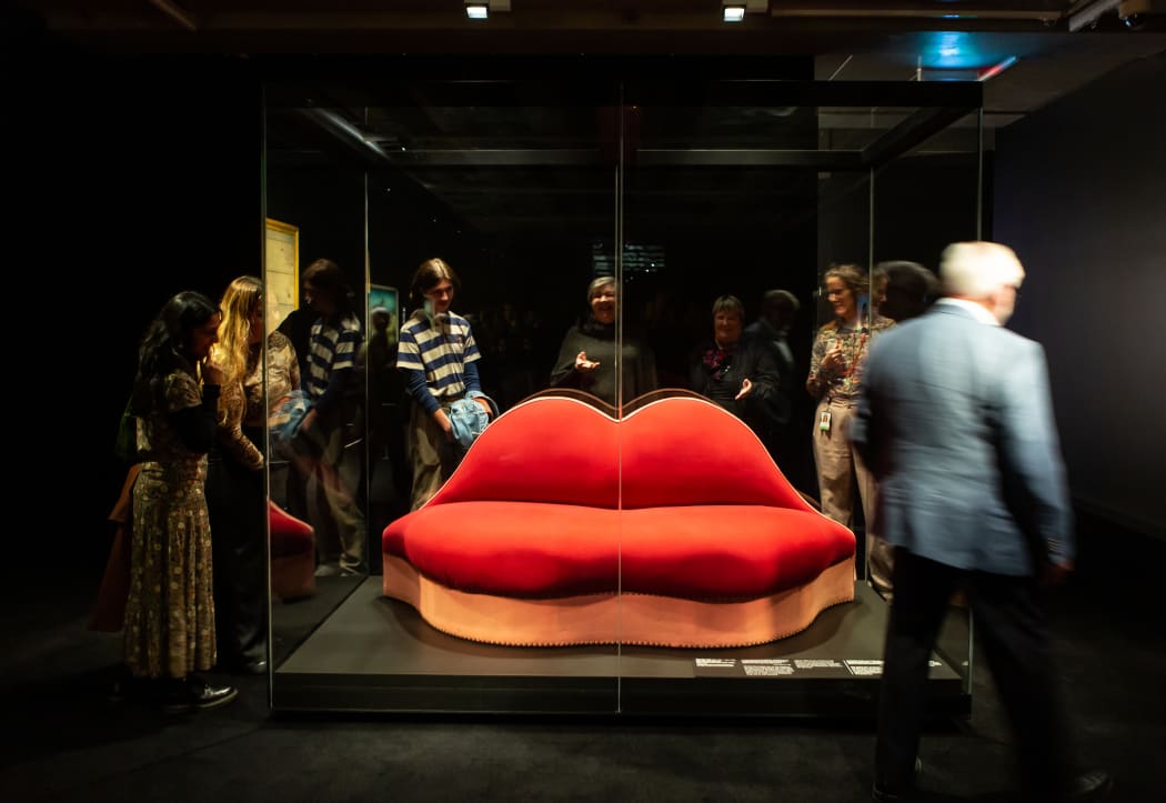Visitors view Salvador Dalí's Mae West Lips Sofa, 1938, in Te Papa's Surrealist Art: Masterpieces from Museum Boijmans Van Beuningen exhibition.