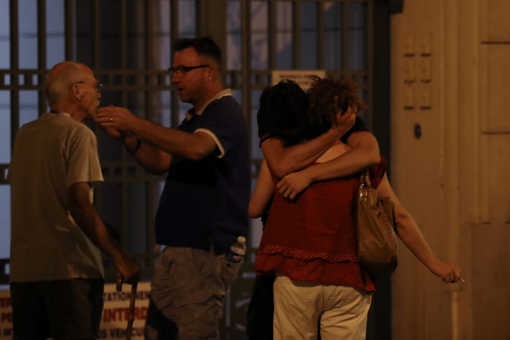 People comfort one another in Nice after the truck attack.