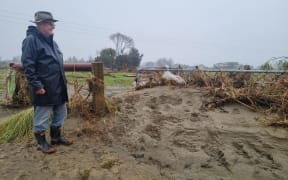 Resident Geoff Grocott who lives nearby surveying the damage at Motueka River.