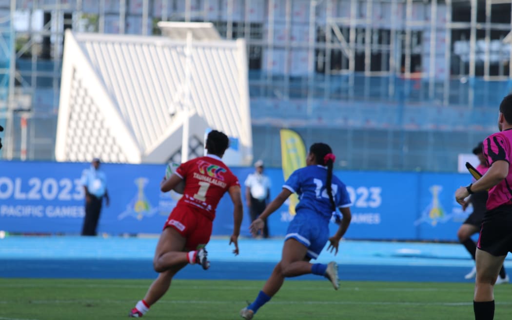 Tonga's Lavinia Tauhalaliku breaks Samoa's defence line at the Pacific Games in Solomon Islands. FT score Tonga 18 - 0 Samoa.
