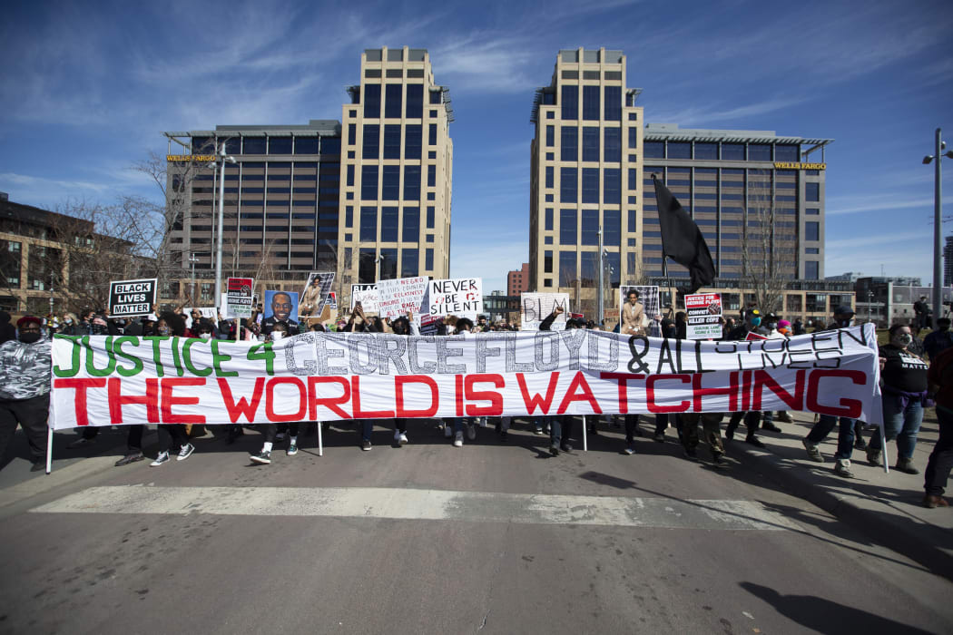 People march during a demonstration in honour of George Floyd on 8 March 2021 in Minneapolis, Minnesota, the day the jury selection began in the trial of former Minneapolis Police officer Derek Chauvin in the death of George Floyd last May.