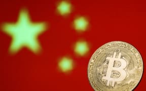 Representation of Bitcoin cryptocurrency is seen with Chinese flag in the background