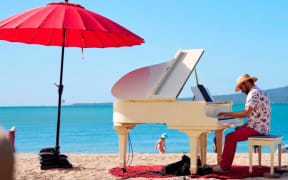 'Undergrand' is billed as a "roaming, open-air musical experience", where performers play a white baby-grand piano in different spots throughout Tauranga.