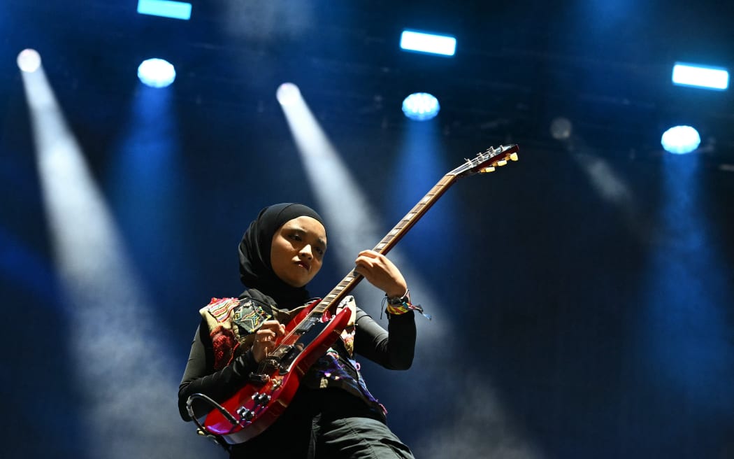 Firda Marsya Kurnia of Indonesian rock band Voice of Baceprot performs on the Woodsies stage on the third day of the Glastonbury festival at Worthy Farm in the village of Pilton in Somerset, southwest England, on June 28, 2024. The festival takes place from June 26 to June 30. (Photo by Oli SCARFF / AFP)
