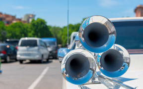Steel chrome horn horn in retro style on the hood of a car
