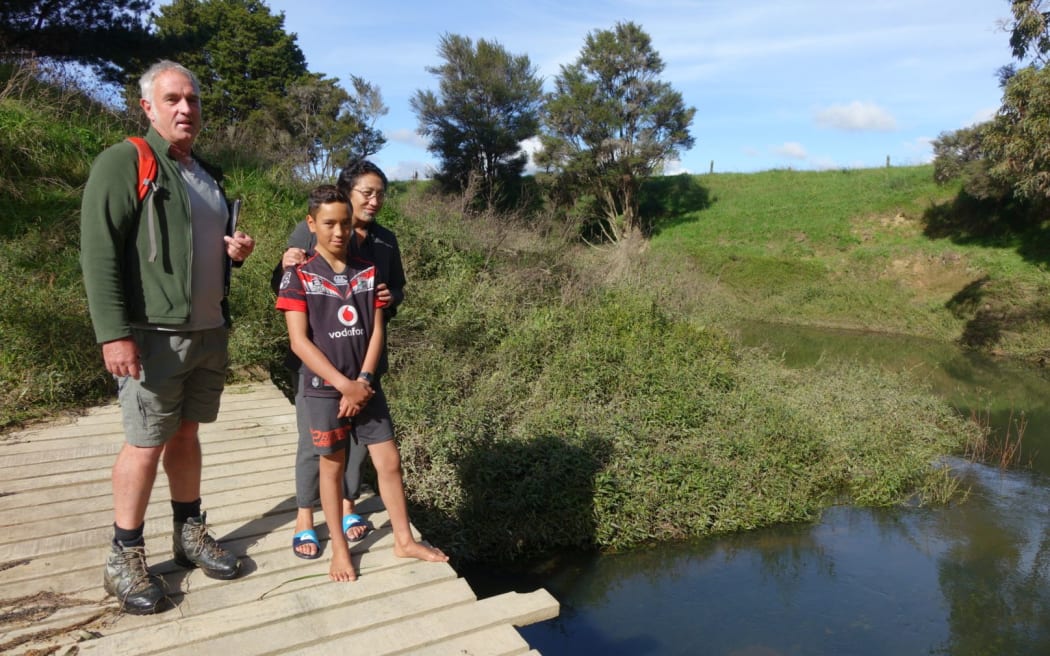 Whakapara marae trustee Tepora Kauwhara and son Tama with ecologist David Wright at the Waima stream.