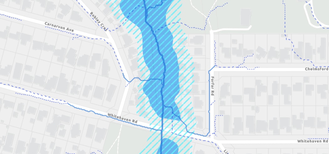 The darker blue represents land on a 'flood plain' where as the area shaded with lighter blue lines shows the area designated 'flood prone'.