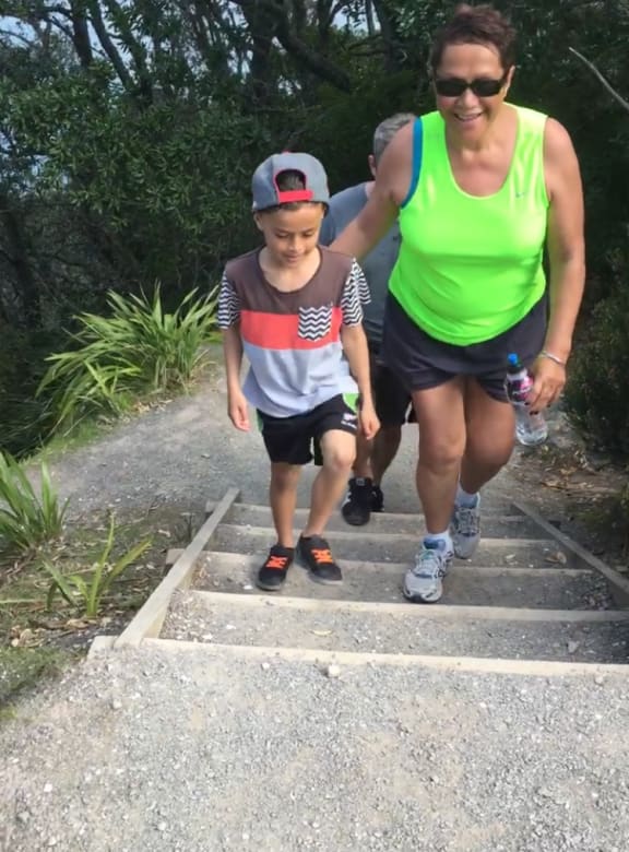 Tiana Bennett today (with her moko Taimana) two years after that first hikoi is able to pace herself when walking to the summit.