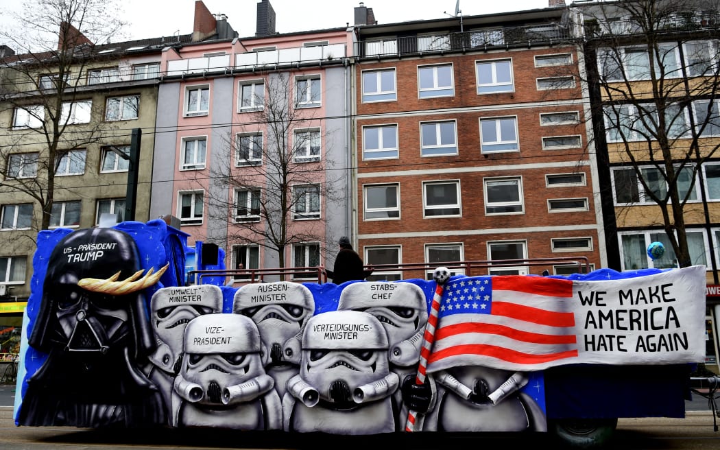 (FILES) A carnival float depicting Star wars character Darth Vader as US President Donald Trump and his cabinet as Imperial Army Trooper takes part in the traditional "Rose Monday" carnival parade in Duesseldorf, western Germany on February 27, 2017. When Donald Trump was inaugurated in 2017, opponents marched in pink knitted "pussy hats" while protesters abroad plastered streets with images of the new US president as "Star Wars" villain Darth Vader. Spool forward eight years -- after his entanglements with the law, two impeachments and divisive pardons of violent criminals -- and the vibe among the anti-Trump resistance movement isn't so much "A New Hope" as its darker sequel, "The Empire Strikes Back." (Photo by PATRIK STOLLARZ / AFP)