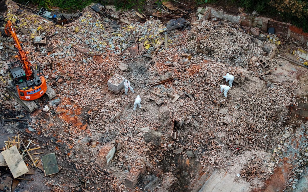 DUDLEY, ENGLAND - AUGUST 25: In this aerial view workers remove dangerous materials from the ruins of the demolished Crooked House pub on August 25, 2023 in Dudley, England. The 18th-century pub famed for its wonky walls, was gutted in a suspected arson attack and demolished within 48 hours without permission. Two men, aged 66 and 33, have been arrested in connection with the incident on suspicion of arson with intent to endanger life. (Photo by Christopher Furlong/Getty Images)