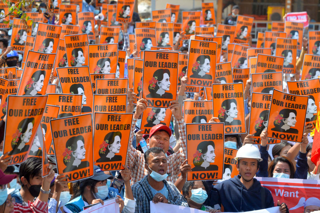 Protesters hold posters with the image of detained civilian leader Aung San Suu Kyi during a demonstration against the military coup in Naypyidaw on February 28, 2021.