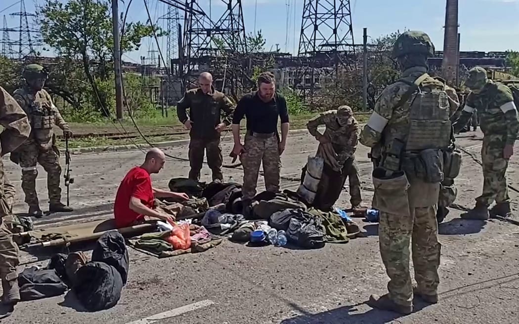A shot from a Russian Defence Ministry video showing Ukrainian fighters being searched by pro-Russian military after leaving the Azovstal steel plant in Mariupol on 17 May.